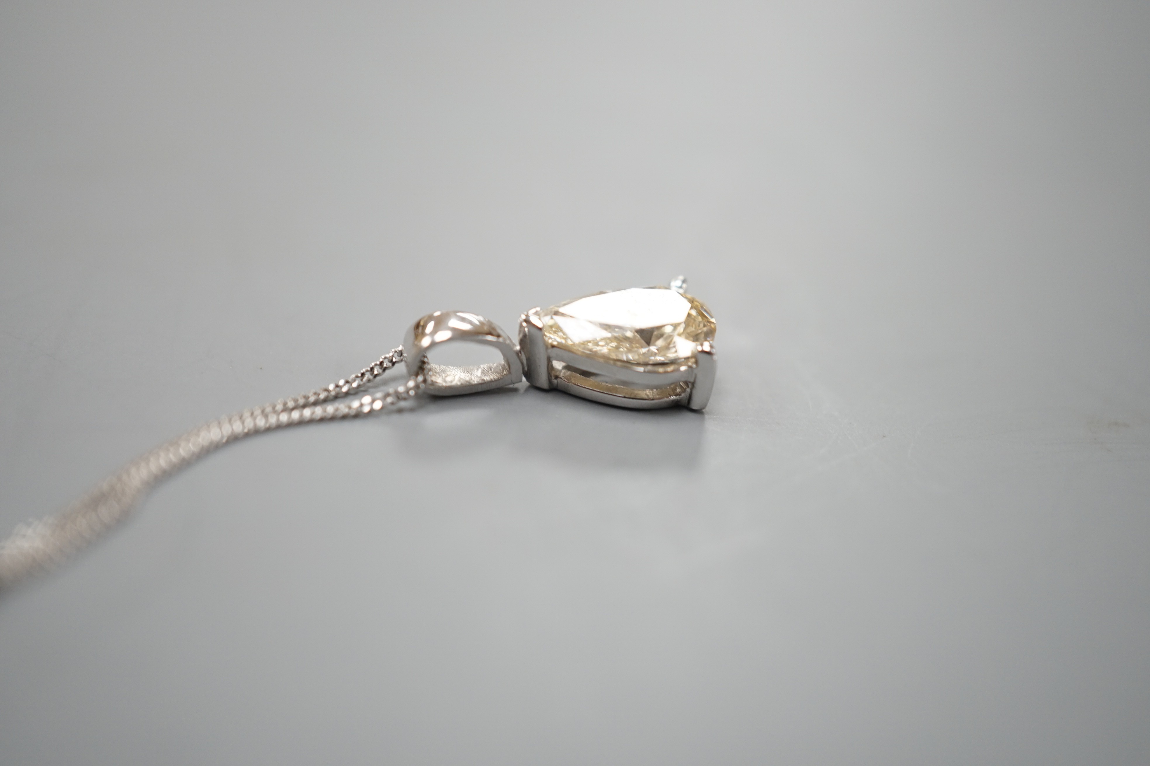 A modern white metal and light brown pear cut diamond set pendant, 14mm, on an 18ct white gold fine link chain, 45cm